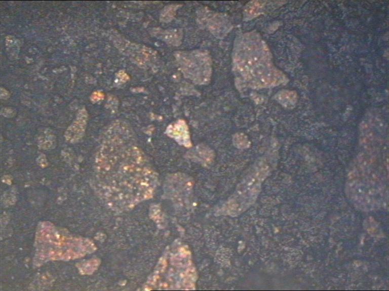 κόκκους του μαγνησίου (αμέταλλο σε χρώμα σκούρο καφέ). την φωτογραφία, φαίνονται οι κόκκοι καθώς και τα όρια τους.