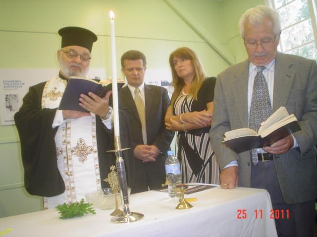 The wet weather forced the people to use their umbrella s to attend the opening of the exhibition, inside the Hall in a