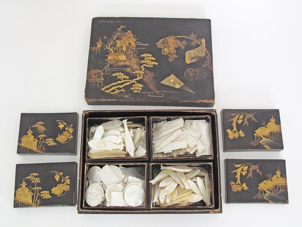 A Japanese lacquered box containing four smaller boxes with a quantity of mother of pearl engraved gaming counters, the boxes with