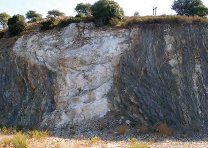 A typical example of Sithonia granite dike invasively intruding into older schistose rocks.