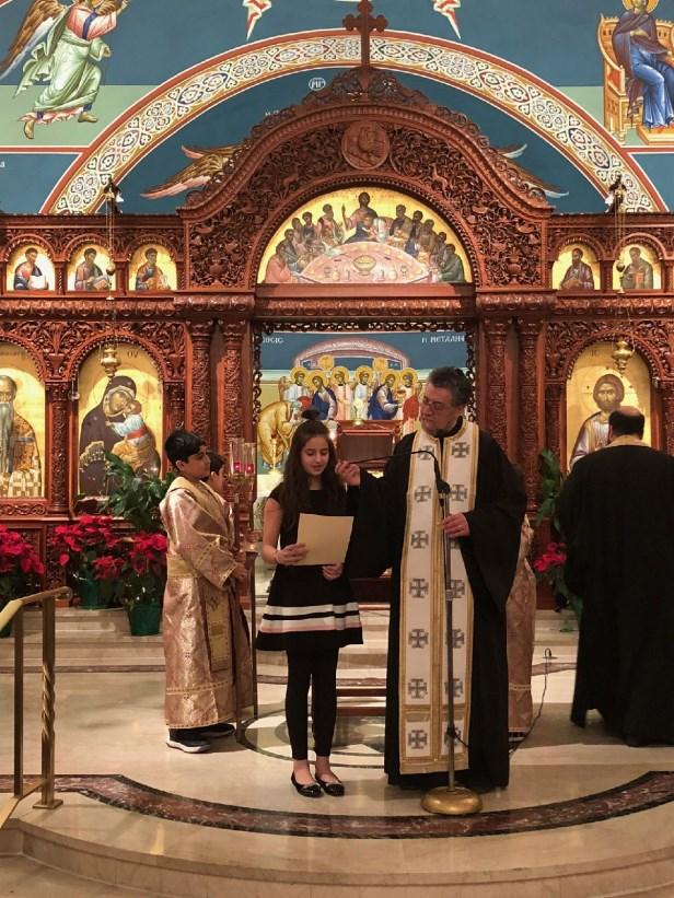 Fr Dean and Fr George cut Vasilopitas in each of the classrooms for