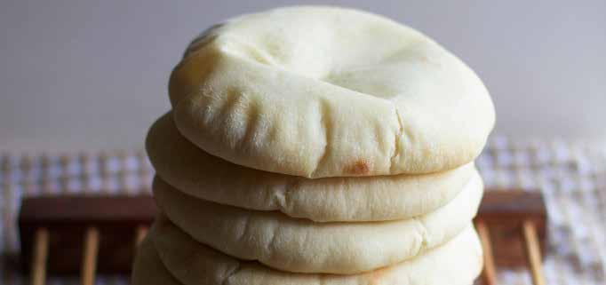 pita bread Syrian Recipe Photo: Audra (The Baker Chick) - 3/4 cup warm water - 3-4 teaspoons active dry yeast - 6 cups bread flour - 1 1/2 teaspoons salt - 1 1/2 cups warm milk - Extra-virgin olive