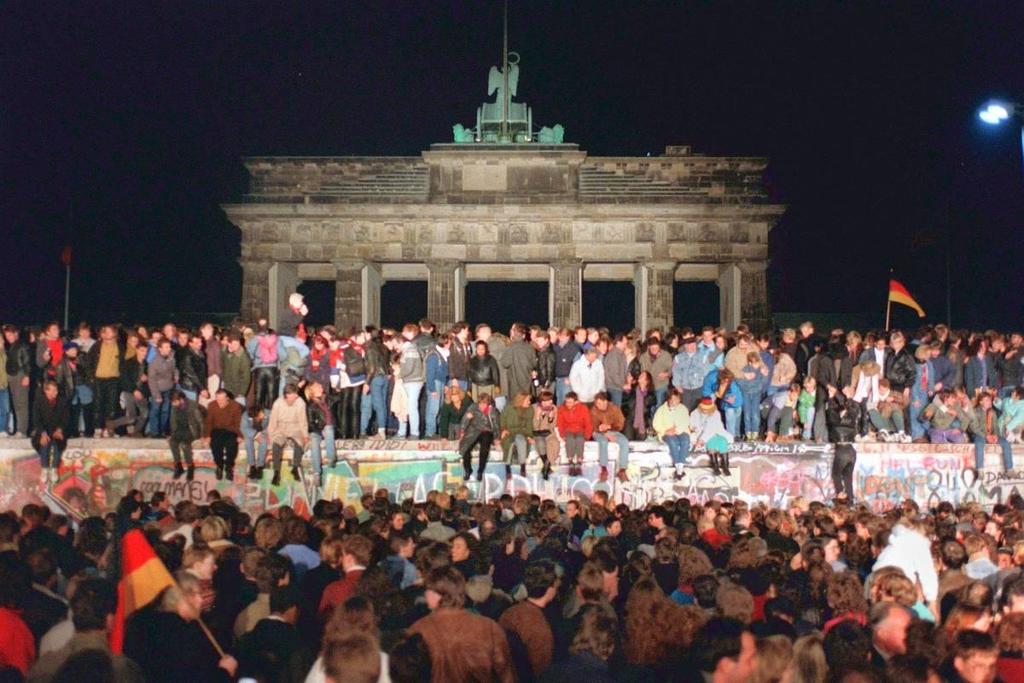 Πολίτες της Ανατολικής Γερμανίας «καταλαμβάνουν» το Τείχος του Βερολίνου και ζητούν την κατεδάφισή του.