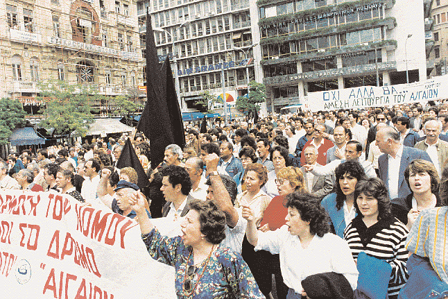 Aθήνα, 14.5.1990. Eργαζόμενοι στα κλωστοϋφαντήρια AIΓAIO A.E., σε πορεία διαμαρτυρίας προς το υπουργείο Eθνικής Oικονομίας.