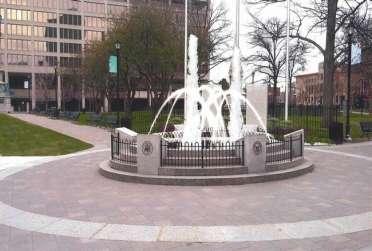 A rendering of the proposed enhancements of the World War II Memorial on Worcester Common. It shows the addition of water jets and a tablet listing the city's war casualties.
