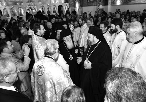His All Holiness offers a gift to Rev. Fr.