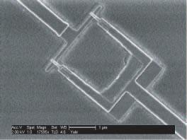 a).1 mm phase qubit transmission line resonator 00 µm b) compact resonator Josephson junctions transmon