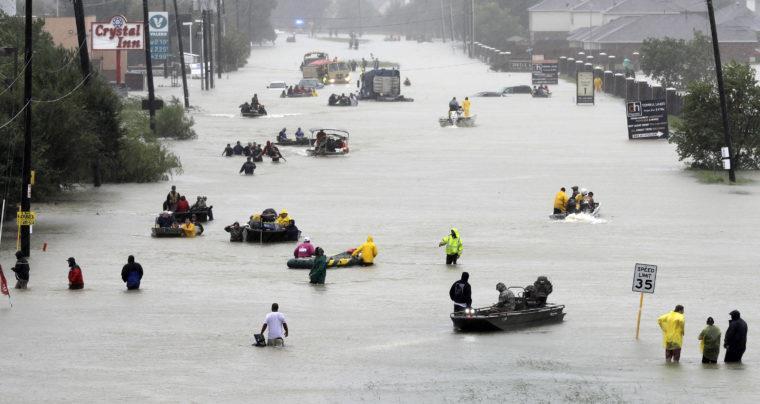 8308 HURRICANE HARVEY RELIEF 4 COLLECTION SUNDAYS 8309 Rescue boats fill a flooded street as flood victims are evacuated as floodwaters from Tropical Storm Harvey rise Monday, Aug.