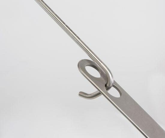F Position blade in the incision, then lock retractor in place by flipping the cam joint into
