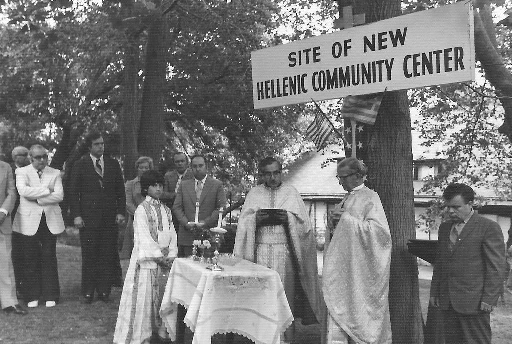 Father Stamos sprinkling Holy Water. Far left is Bill Athan. Katina Kogamihalis (Michaels), representing Philoptochos, turning over the soil.