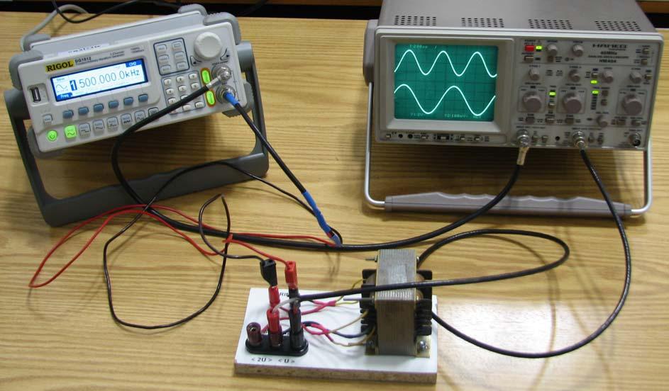 VAJA 16 Slika 16.3. Merjenje signalov na električnem transformatorju. 16.3. Obrazložitev in opis poteka vaje Pri vaji je potrebno izmeriti napetost na primarnem navitju električnega transformatorja in napetost na njegovem sekundarnem navitju.
