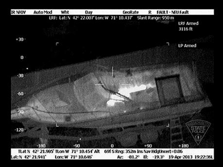 Image 1: 2013, one of five photos released of Boston bombing suspect in hiding, black and white infrared video still.