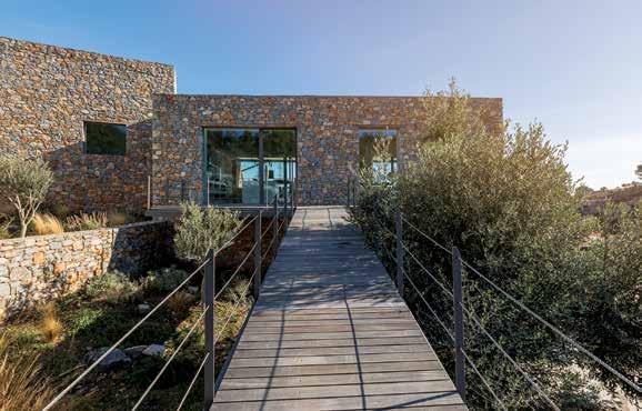 The volumes, clad in local stone, in a perfect balance of colours, textures and materials, follow the coastline, welcome the East and look to